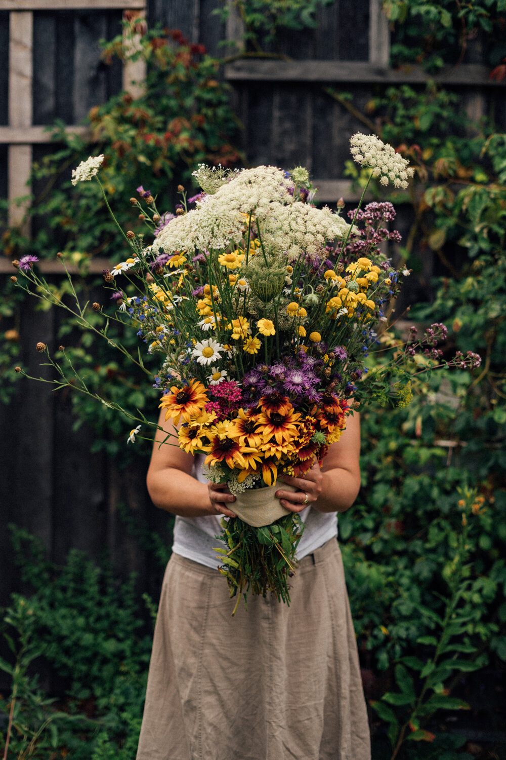 Frau mit großem selbstgemachtem Wildblumenstrauß